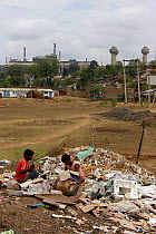 Teenagers sorting rubbish for recycling in industrial slum, Bhopal, Madhya Pradesh, India, November 2008