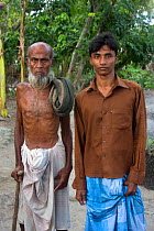 Muslim grandfather with grandson, Ganges delta, Bangladesh, November 2008