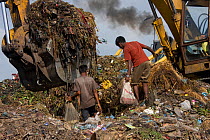 Children looking for recyclable objects in landfill site, Dhaka, Bangladesh, July 2008