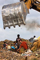 Children looking for recyclable objects in landfill site, Dhaka, Bangladesh, July 2008