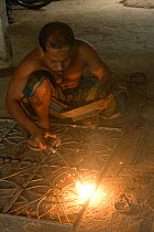 Man learning welding on a rural training scheme organised by an NGO, Uttaran, Ganges delta,  Bangladesh, November 2008