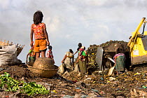 Adults and children searching for recyclable objects in landfill site, Dhaka, Bangladesh, November 2008