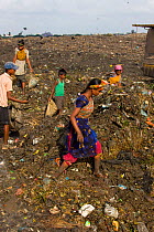 Children searching for recyclable objects in landfill site, Dhaka, Bangladesh, November 2008