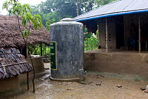 Water tank provided by Clean water project initiated by NGO, Uttaran, Ganges delta, Bangladesh, November 2008