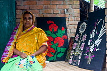 Woman embroidering cloth as part of a craft scheme to alleviate rural poverty, Ganges delta, Bangladesh, November 2008