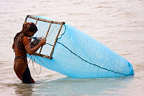 Child fishing for shrimp fry in coastal waters, Ganges delta, Bangladesh, November 2008