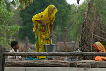 Woman collecting water from well, village life, Madyha Pradesh, India, Asia, November 2008