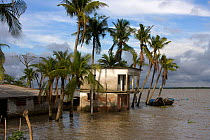 Home threatened by rising sea levels, Passur river, Ganges delta, climate change, Bangladesh, November 2008