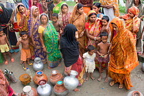 Women collecting water at well, issue of increased salinity due to increase of shrimp farming in the Ganges delta, Bangladesh, November 2008