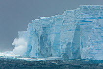 Waves crashing against ice cliffs of iceberg off the southern tip of South Georgia Island in wind storm, Southern Ocean, Antarctic Convergence, November 2008