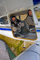 Wildlife Photographer, Ingo Arndt, flying in bush plane with door removed for taking aerial pictures, Arctic National Wildlife Refuge, Alaska, June 2009