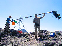 Ted Giffords (cameraman) assisted by Jeff Wilson  swings the end of a jib arm' in order to glide the camera over Erta Ale, a bubbling lava lake, for Mountains episode of the BBC tv series Planet Eart...