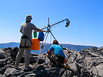 Ted Giffords (cameraman) assisted by Jeff Wilson swings the end of a jib arm' in order to glide the camera over Erta Ale, a bubbling lava lake, for Mountains episode of the BBC tv series Planet Earth...