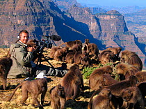Wildlife biologist, Dr. Chadden Hunter, filming Gelada baboons (Theropithecus gelada)  for the Mountains episode of the BBC tv series Planet Earth, Simien Mountains National Park, Ethiopia, Oct 2003 (...
