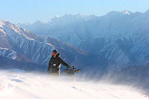 Camerman, Mark Smith, scouts Himalayan valleys over 2km deep in search of the elusive snow leopard, for the Mountains Episode of the BBC tv series Planet Earth, Himalayas, northern Pakistan (on the bo...