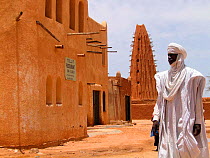 A local Tuareg tribesman walks past the guesthouse where the film crew were based for filming sandstorms for the Deserts Episode of the BBC tv series Planet Earth, the famous mud-tower mosque of Agade...