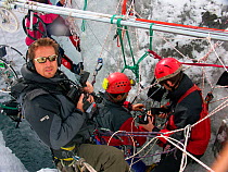 Chadden Hunter (cameraman) and film crew filming inside 'moulins', the ice caves that drain meltwater through glaciers, Gorner Glacier, Alps, Switzerland, October 2005.  Filming for the Mountains Epis...