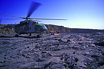Film crew being dropped off by Ethiopian military helicopter beside the permanently bubbling Erta Ale lava lake, Erta Ale volcano, Danakil Desert, Ethiopia, November 2003.  Filming for the Mountains e...