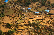 Aerial view of houses surrounded by terraced fields, Himalayan foothills, Nepal, December 2007