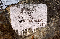 Save the Musk deer sign painted on rock on trail, Sagarmatha National Park, Khumbu, Himalayas, Nepal, December 2007