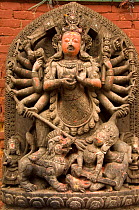 Stone statue of Hindu goddess Durga killing a demon, Mahisasur, Bhaktapur, Kathmandu, Nepal, December 2007