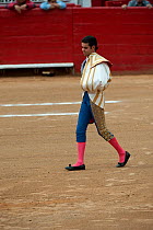 Young matador walking out to salute judge in bullring before bullfight, Plaza de Toros, Mexico City, Mexico