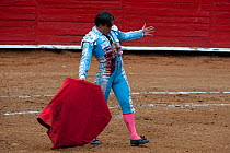 Matador with red cloak in final stages of bullfight, Plaza de Toros, Mexico City, Mexico