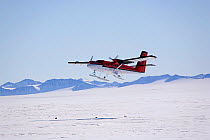 Twin Otter with skis takes off at Patriot Hills using a snow skiway. Antarctica, January 2006.