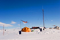 Radio tent with aircraft taking-off in background, Patriot Hills camp, Antarctica, January 2006.