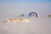 Gas cylinders in blowing snow during a storm, with tent behind. Patriot Hills, Antarctica, January 2006.