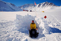 Woman using the field toilet at Mount Vinson Base Camp. Vinson Massif, Antarctica, January 2006.