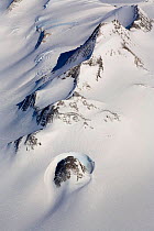 Rocky peak in the Ellsworth Mountains with a dramatic wind scoop, and an Arete running diagonally. West Antarctica, January 2006.