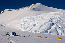 Icefall behind Vinson Base Camp, with tents in foreground. Vinson Massif, Ellsworth Mountains, Antarctica, January 2006.