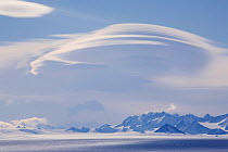 Peaks of the Ellsworth Mountains, with orographic clouds above and blue ice below. Antarctica, January 2006.