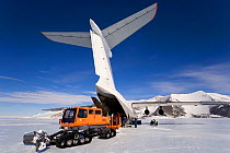 Unloading the Ilyushin 76TD with a Tucker-terra and sled on the Blue Ice Runway at Patriot Hills. Antarctica, January 2006.