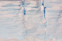 Crevasses in the side of a tabular icebergs, with the annual layers visible. Antarctica, October 2006.