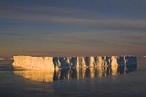 Tabular iceberg reflected at sunset in Erebus and Terror Gulf. Weddell Sea, Antarctica, October 2006.