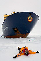 Tourist joking in front of the icebreaker "Kapitan Khlebnikov", Antarctica, October 2006.