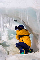 Photographing icicles hanging off the ice on Snow Hill Island. Antarctica, October 2006.