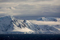 Mountains and bands of cloud and high wind in the Gerlache Strait, Southern Ocean, Antarctica, October 2006.