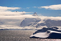 Mountains, bands of cloud and high wind in the Gerlache Strait, Southern Ocean, Antarctica, October 2009.