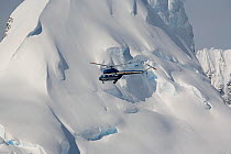 Russian Mi-2 helicopter from the Kapitan Khlebnokov flying past glaciers in the Gerlache Strait. Antarctica, October 2006.
