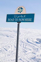 Road to Nowhere street sign in Iqaluit with fish logo and syllabics. Nunavut, Canada, April 2008.