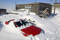 Cars burried by the winter snow outside a home in Iqaluit. Nunavut, Canada, April 2008.