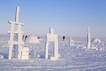 Igloos and Inukshuks built from snow as part of the celebrations for Hamlet Day in Igloolik. Nunavut, Canada, April 2008.