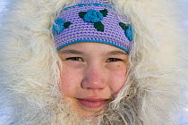 An Inuit girl from Igloolik wearing a parka with a fox fur hood. Nunavut, Canada, April 2008.