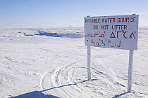 Sign warning against dumping rubbish near water reservoir of drinking water, near Igloolik. Nunavut, Canada, April 2008.