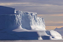 Iceberg catching the low light, the buttresses have been softened in shape by water. East Greenland, September 2005.