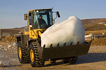 Front loader collecting glacial ice for community water supply in Qaanaaq. Northwest Greenland, September 2008.