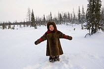 Komy girl, aged 2, playing in the snow at her family's winter camp. Yamal, Northwest Siberia, Russia, February 2007. Editorial use only.